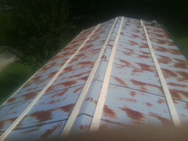 Rusted metal roof panels with new wood purlins before replacement — Storm Damage Roof Repair in Bamberg by Roofing Brothers